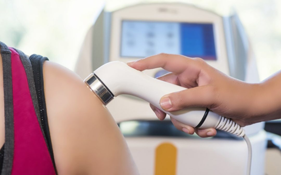 A picture of a person performing ultrasound on a patient's arm.